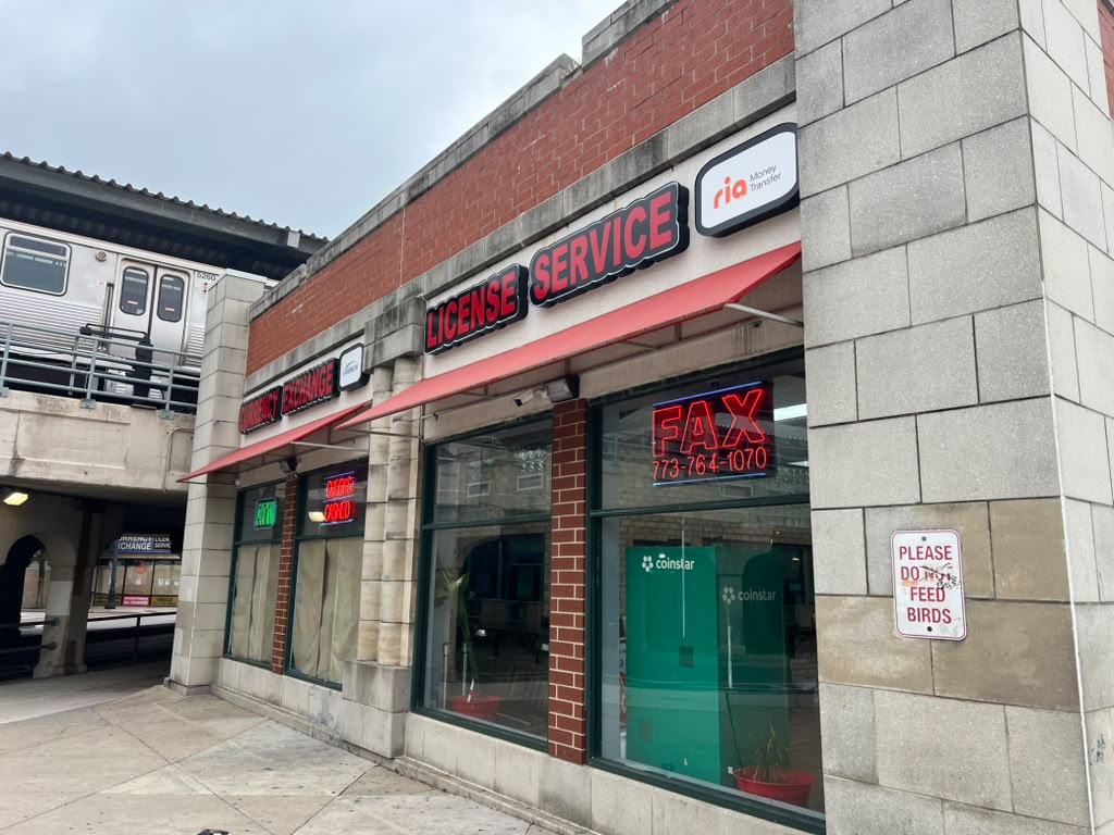 Side view of the License Service storefront with fax number sign